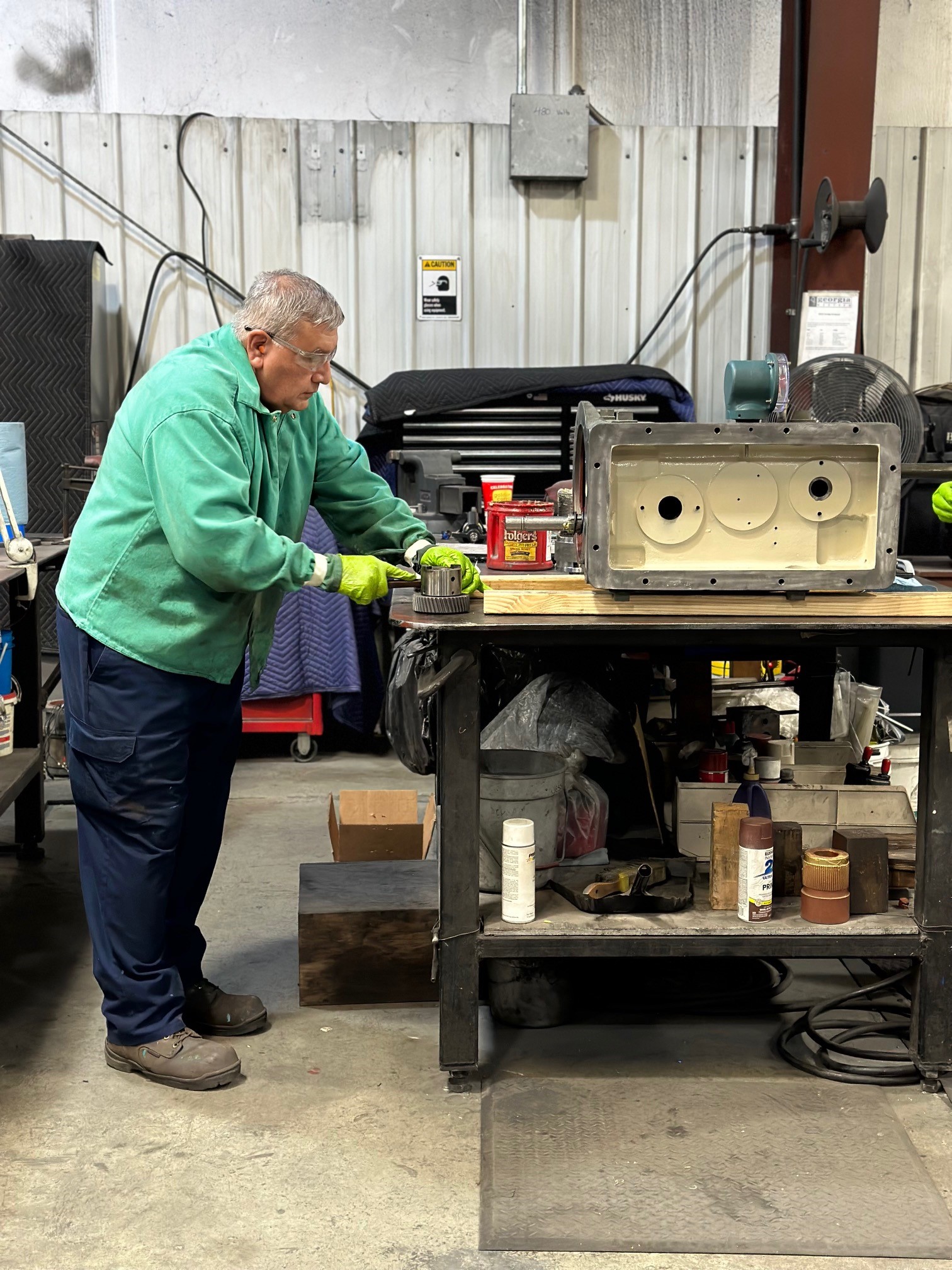 Georgia Western technician working on actuator equipment at a shop workbench